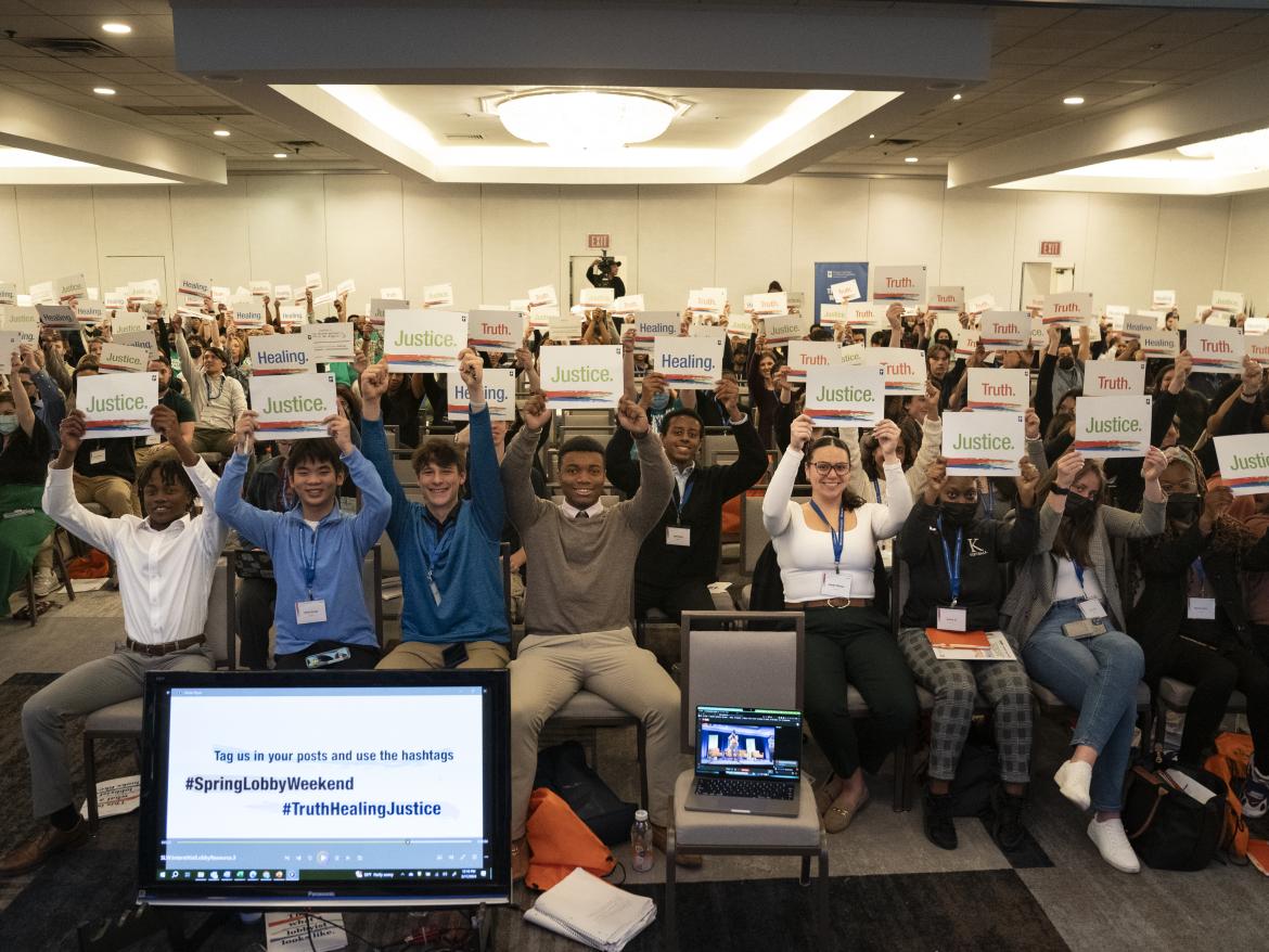 Young advocates hold up signs for Truth and Healing at Spring Lobby Weekend 2024. 