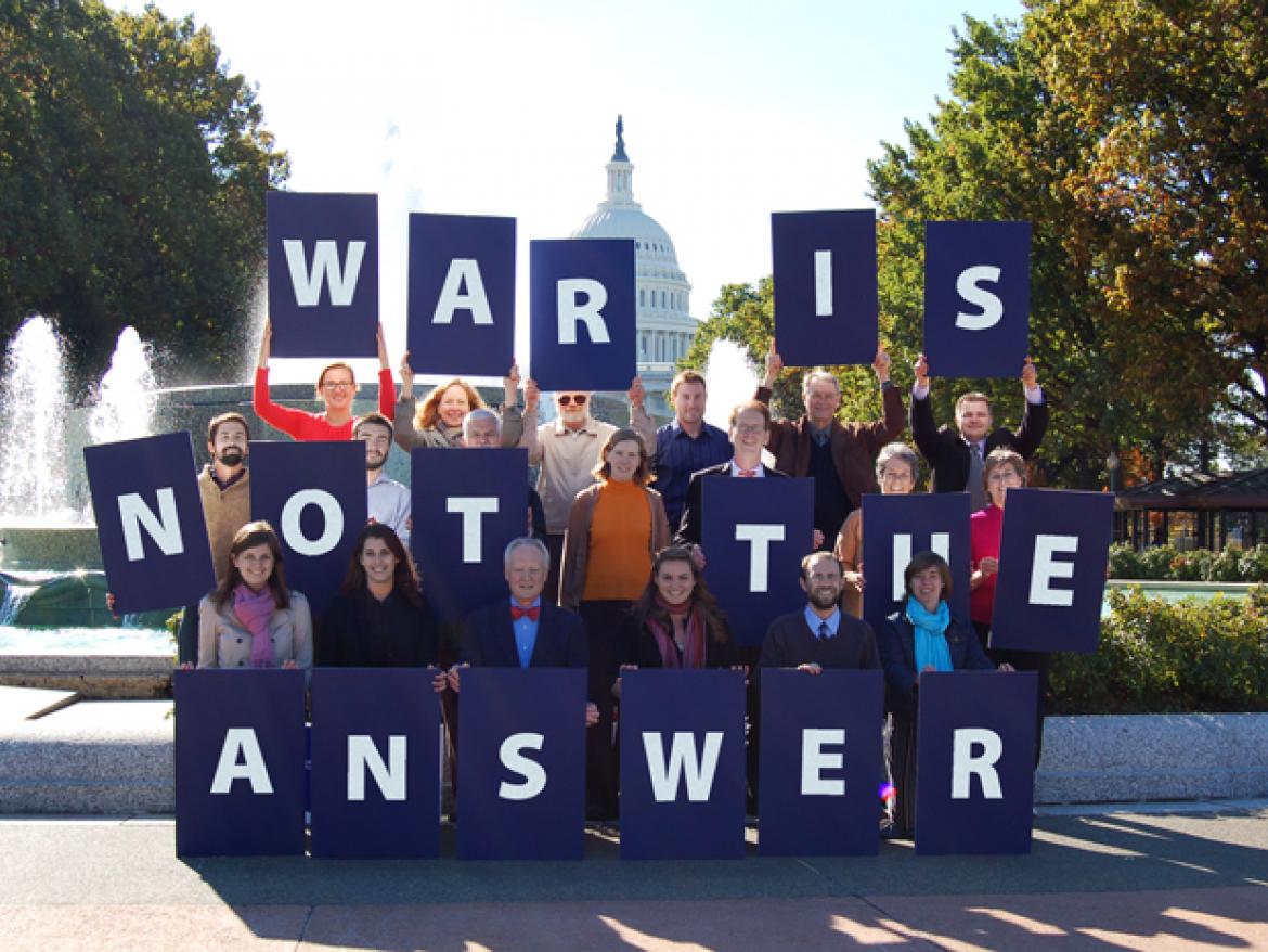 Advocates hold letters that spell out "War is Not the Answer" in front of U.S. Capitol