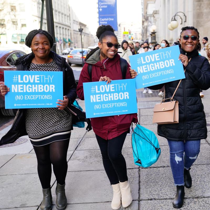 Spring Lobby Weekend 2022 particpants walk to White House holding "love thy neighbor" signs