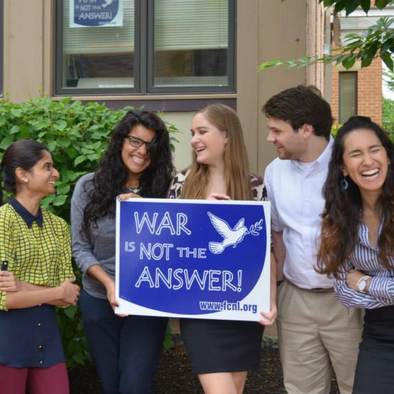 Interns hold a War Is Not the Answer sign