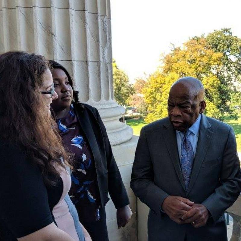 Five people meet with Rep. John Lewis in front of the Capitol