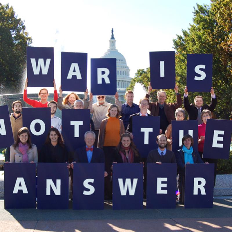 Advocates hold letters that spell out "War is Not the Answer" in front of U.S. Capitol