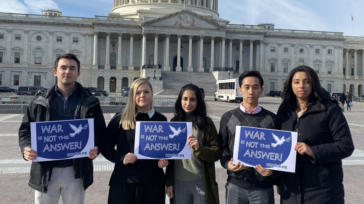 FCNL Young Fellows holding War is Not the Answer signs in front of U.S. Capitol
