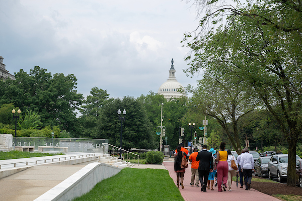 2024 Violence Interrupter Symposium participants walking with Capitol in background