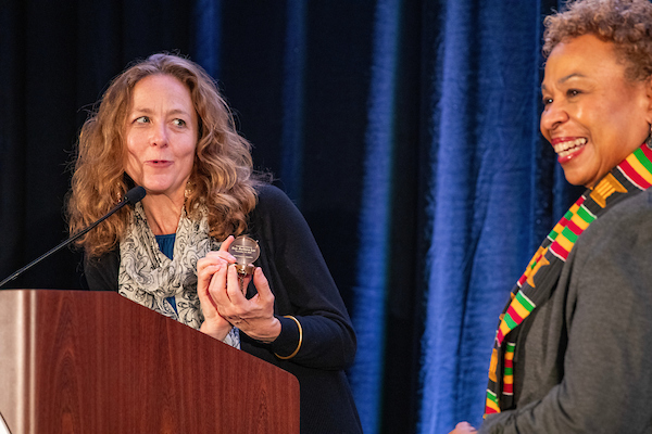 Bridget Moix presenting Rep Barbara Lee with the Compass Award, QPPI 2024