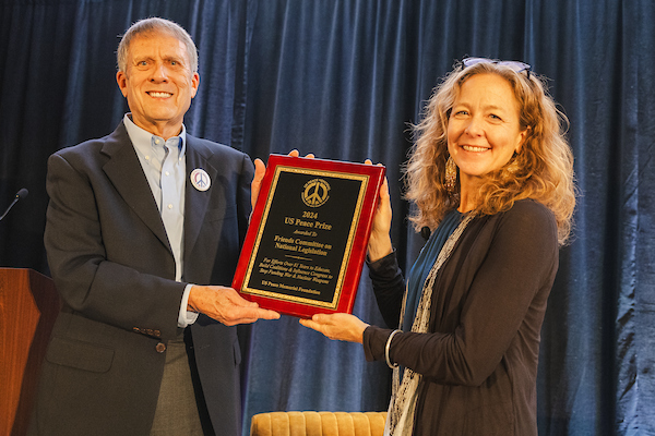 Bridget Moix recieving the 2024 U.S. Peace Prize from Michael Knox