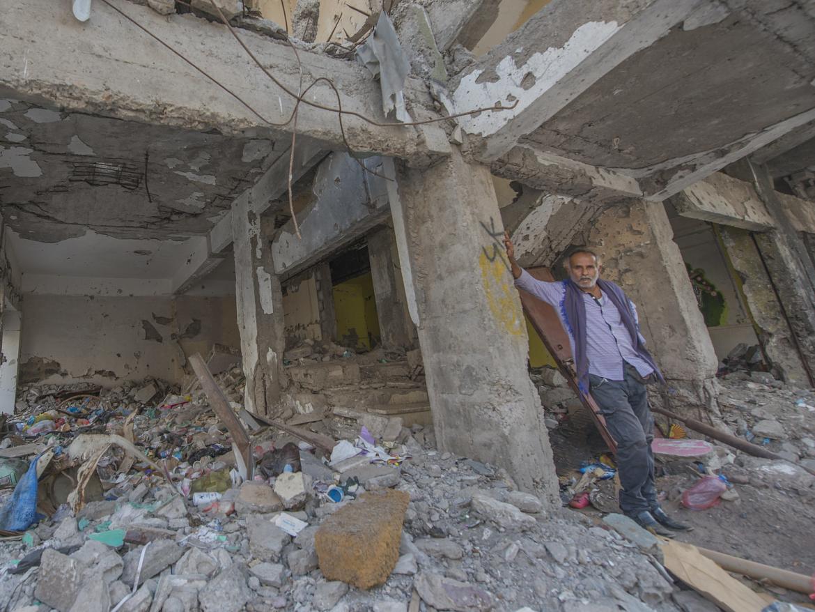 A man stands the rubble of a building destroyed in an air raid in a neighborhood in Aden, Yemen. 