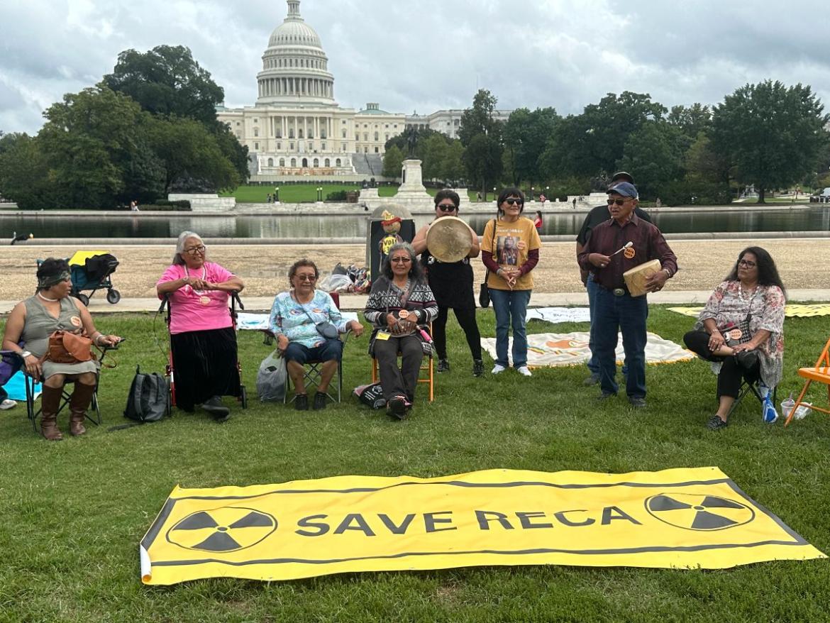 A group of Native elders with a sign reading "Save RECA" in front of the U.S. Capitol