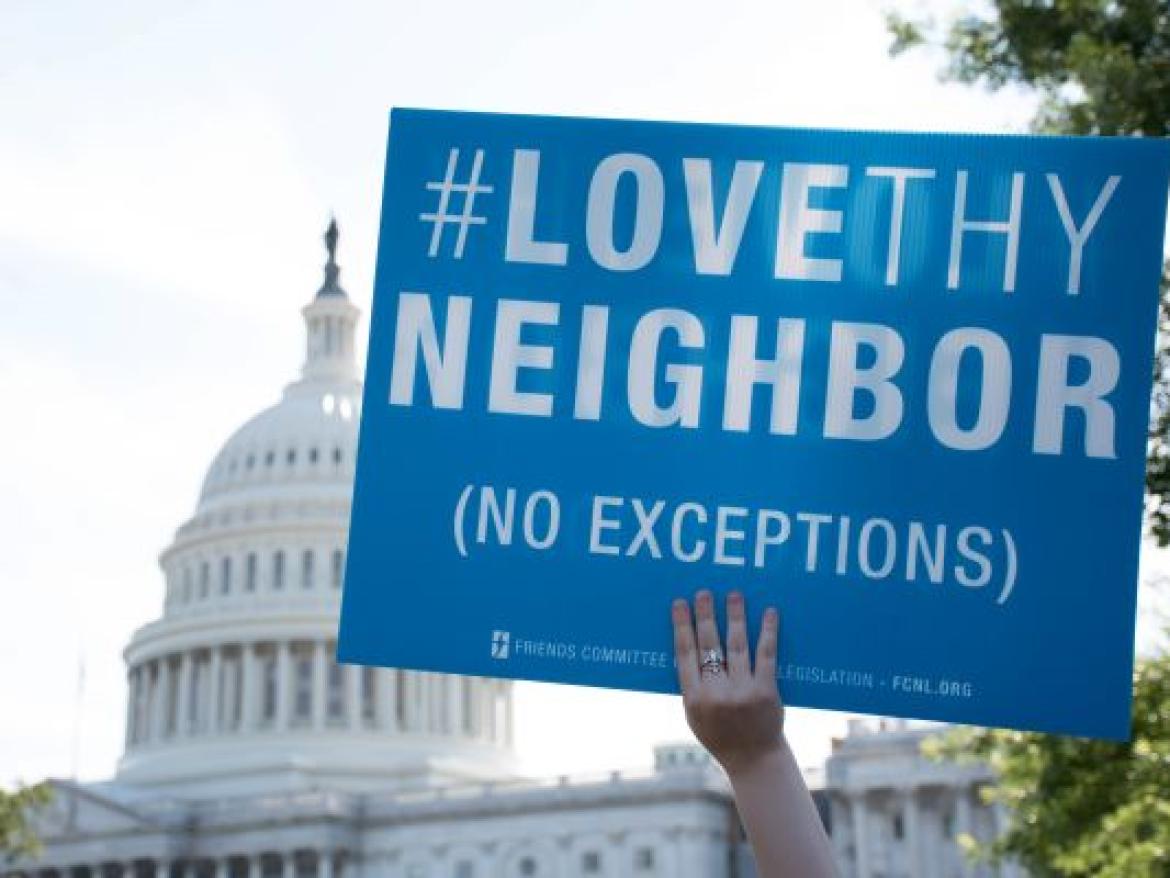 Love thy Neighbor sign in front of Capitol