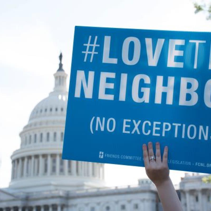 Love thy Neighbor sign in front of Capitol