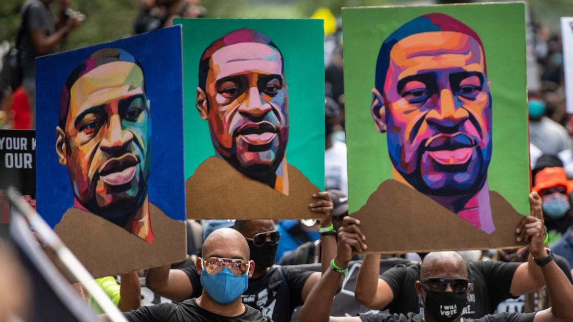 Black Lives Matter Marchers in DC hold George Floyd signs