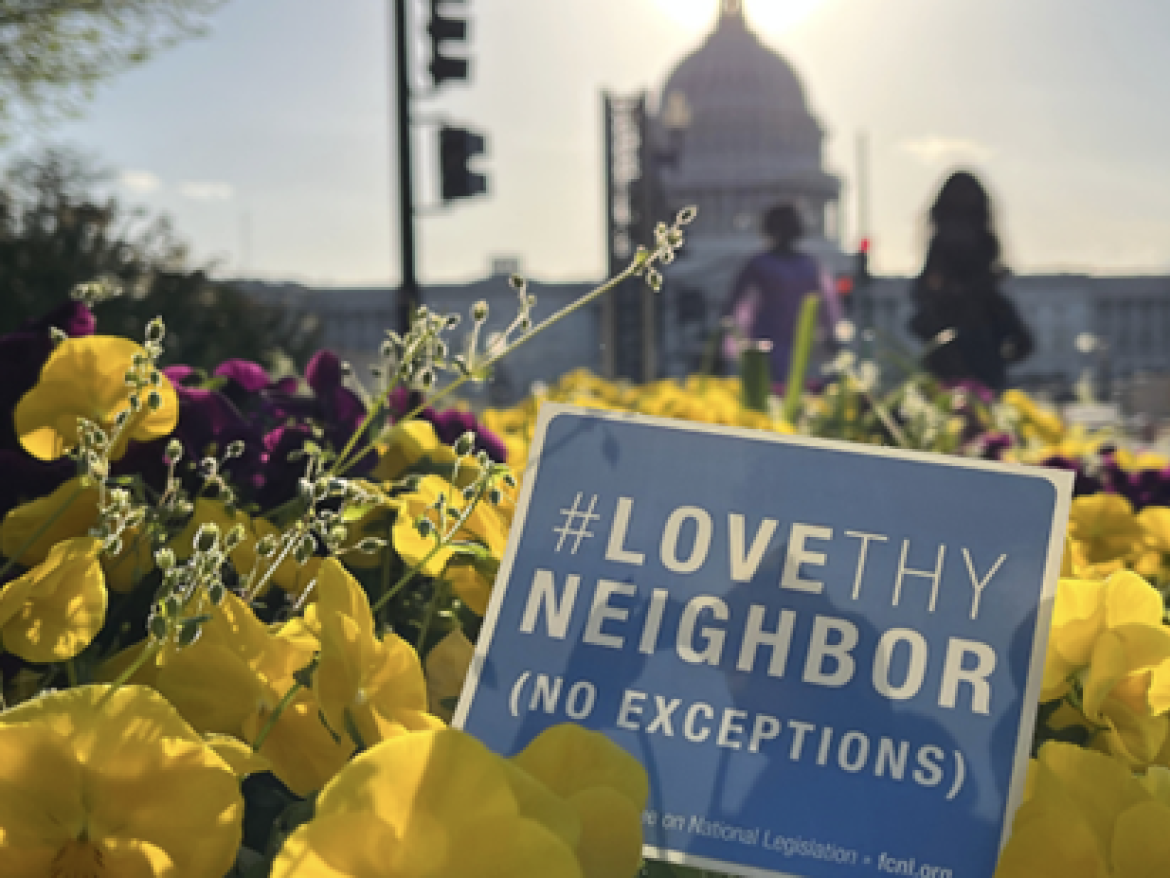 Capitol Building with Love Thy Neighbor sign